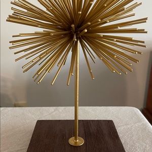 Metal starburst gold sculpture